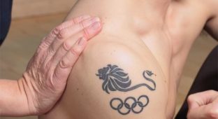 olympic tattoo on upper shoulder