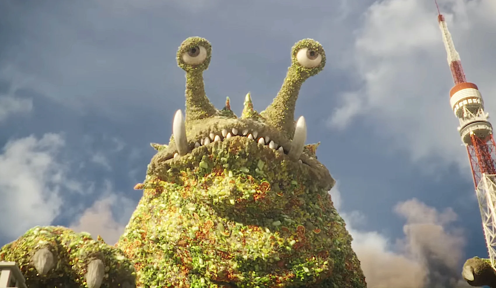 Giant moss-covered monster with multiple eyes near Tokyo Tower in a fantasy setting