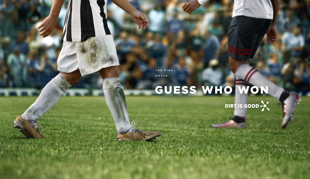adivinha quem ganhou. Soccer players on the field with dirty and clean uniforms, text overlay says "Guess Who Won," campaign slogan "Dirt is Good" visible.