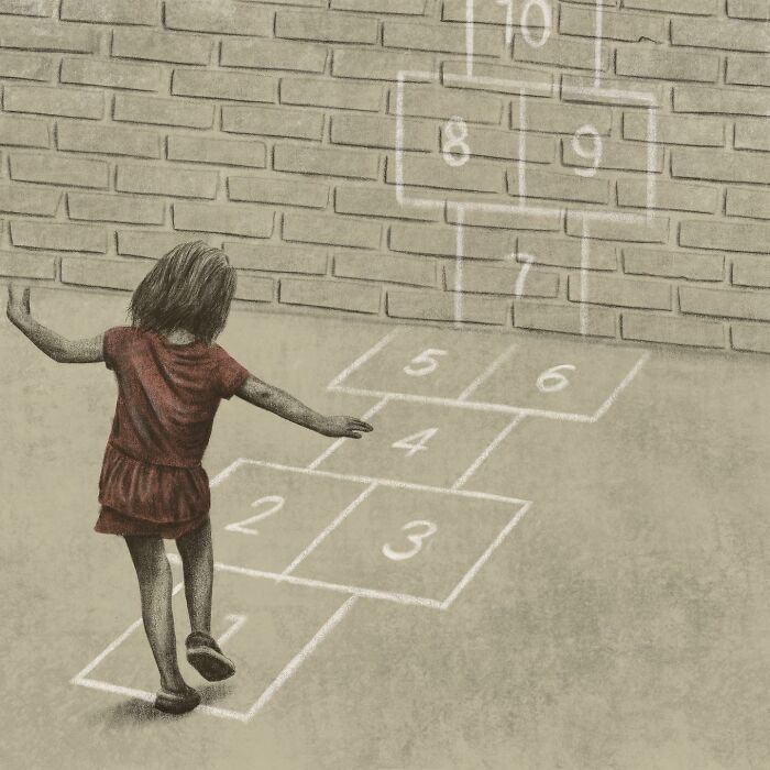 Young girl playing hopscotch on a playground with chalk-drawn numbers on pavement