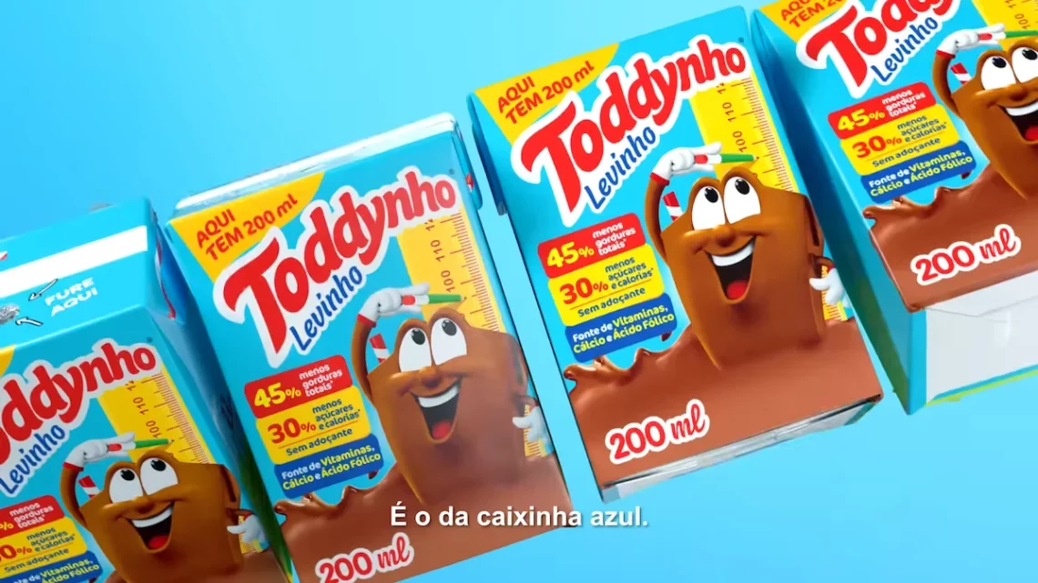 Levinho. Pack of Toddyinho Levity chocolate milk boxes with mascot against a blue background.