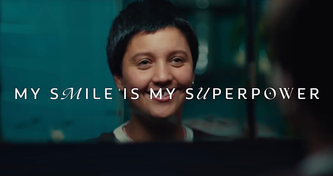Person smiling with text "My smile is my superpower" on inspirational background