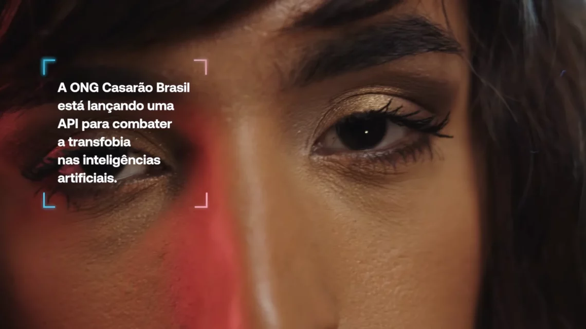 Close-up of a person's eye with shimmering eyeshadow and text announcing a new API by Casarão Brasil to fight transphobia in artificial intelligence.