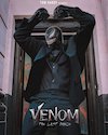 Venom movie poster featuring character in black costume with ominous background