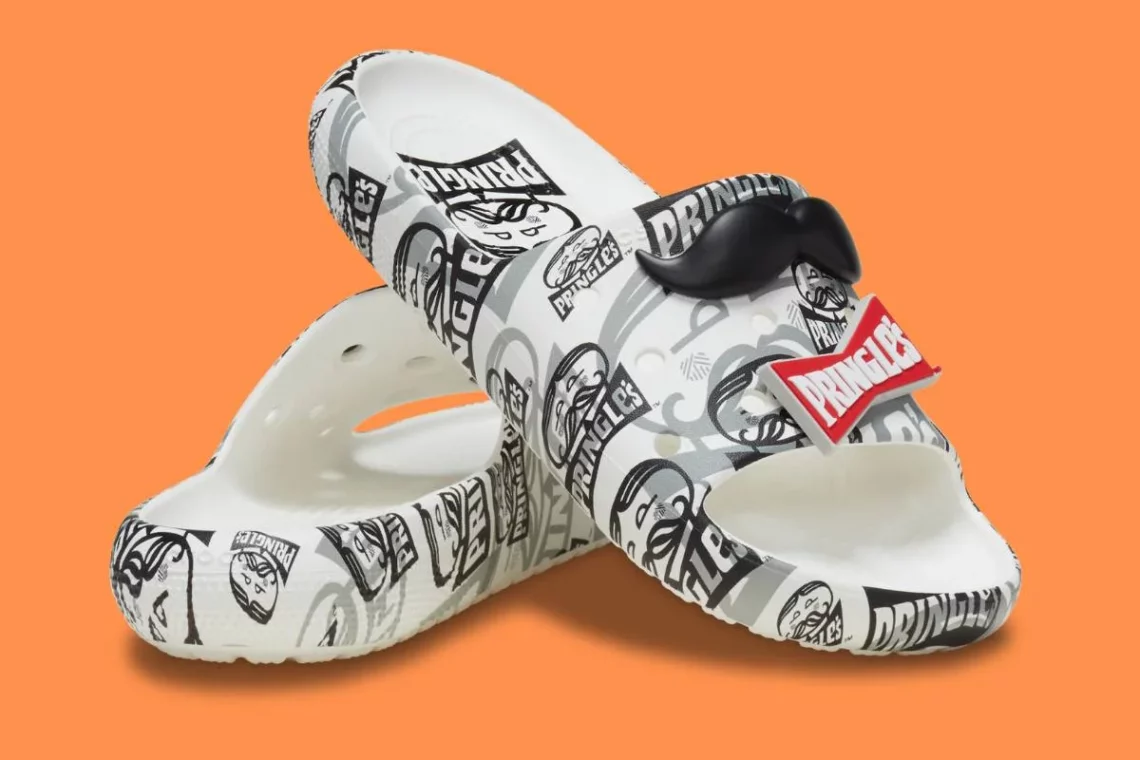 Printed graphic clogs with Pringles branding on orange background.