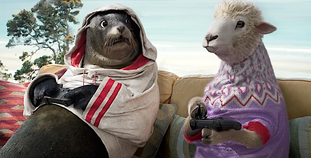 Animated seal and sheep characters playing video games on a couch with a serene background.