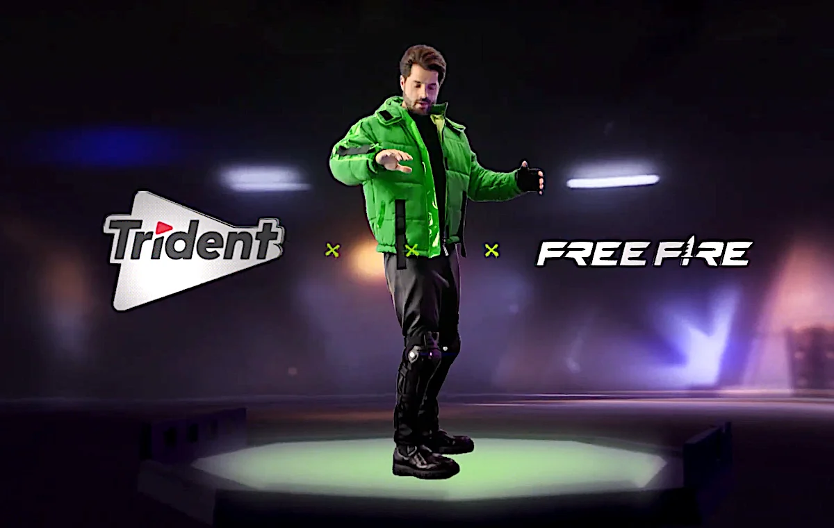 Man in green jacket showcasing dance move on Free Fire and Trident collaboration stage.