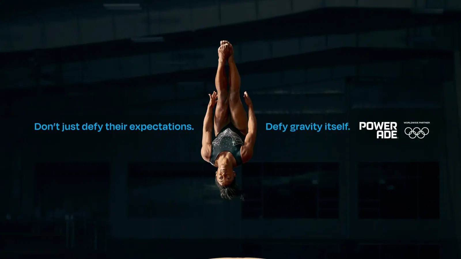 Athlete performing mid-air flip in Powerade Olympic advertising campaign with motivational slogans