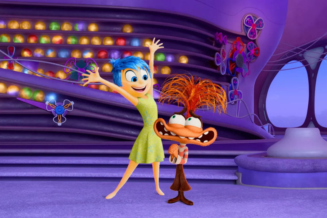 Animated characters Joy and Fear from a popular movie in a colorful command center setting with glowing memory orbs.