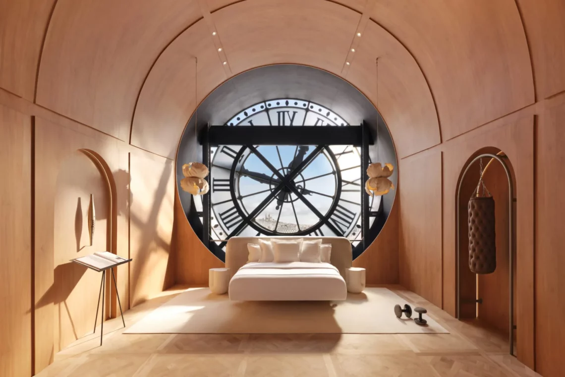 Luxury modern bedroom interior with arched wooden walls and a large clock window facing city views.