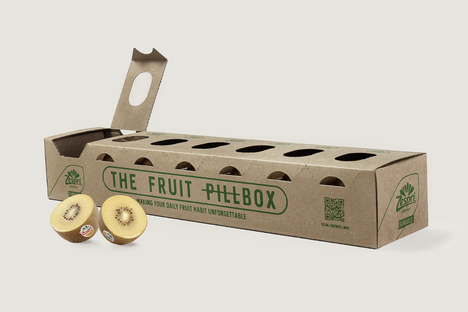 Eco-friendly cardboard fruit packaging box labeled "The Fruit Pilebox" with two halves of a kiwi fruit in front.
