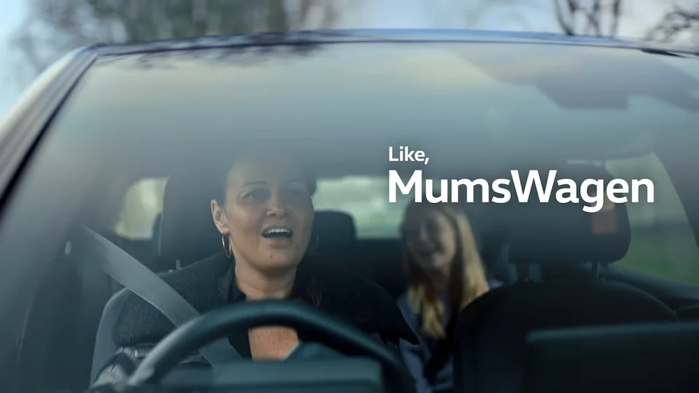 YourWagen. Mother and daughter enjoying a car ride together with text "Like, MumsWagen" displayed on the windshield.